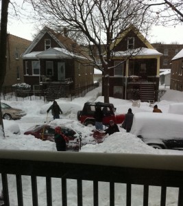 View of Chicago street after huge snowfall, good samaritans helping jeep stuck in snow